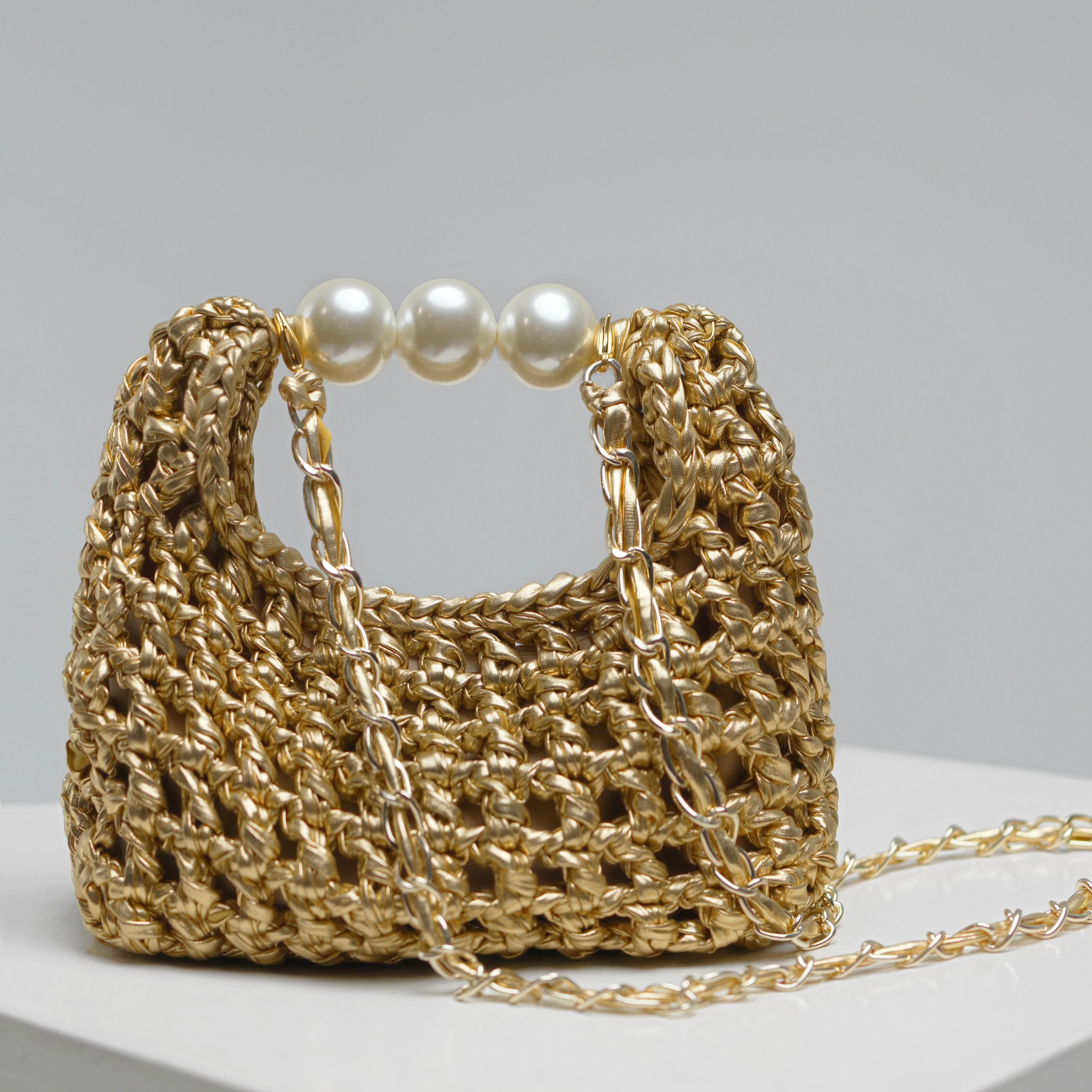 Detail of ZOEL’s handmade Luna bag with shimmering gold leather effect and pearls