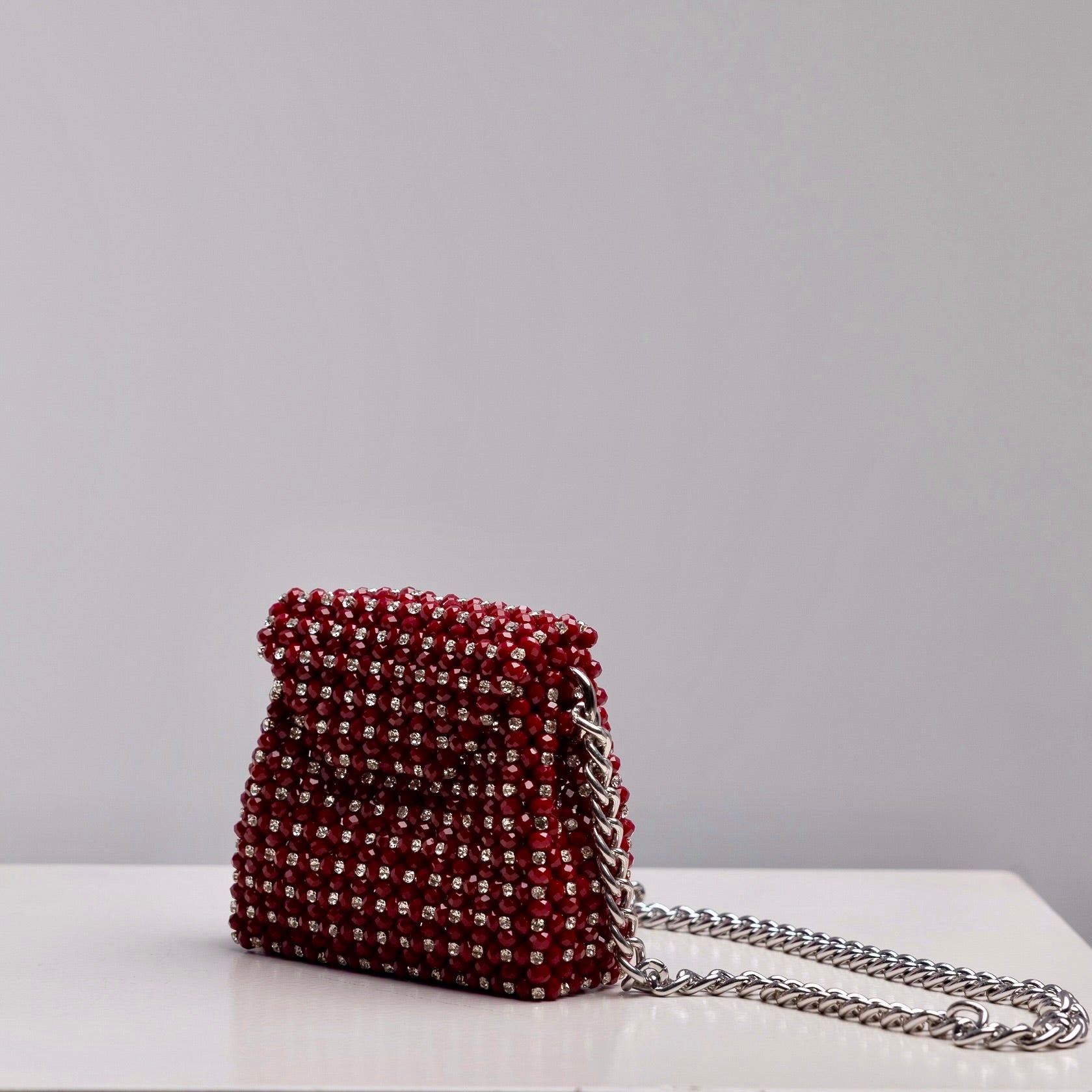 Mini Aurora crossbody bag in burgundy with silver rhinestone crystals and silver chain, handcrafted by ZOEL.