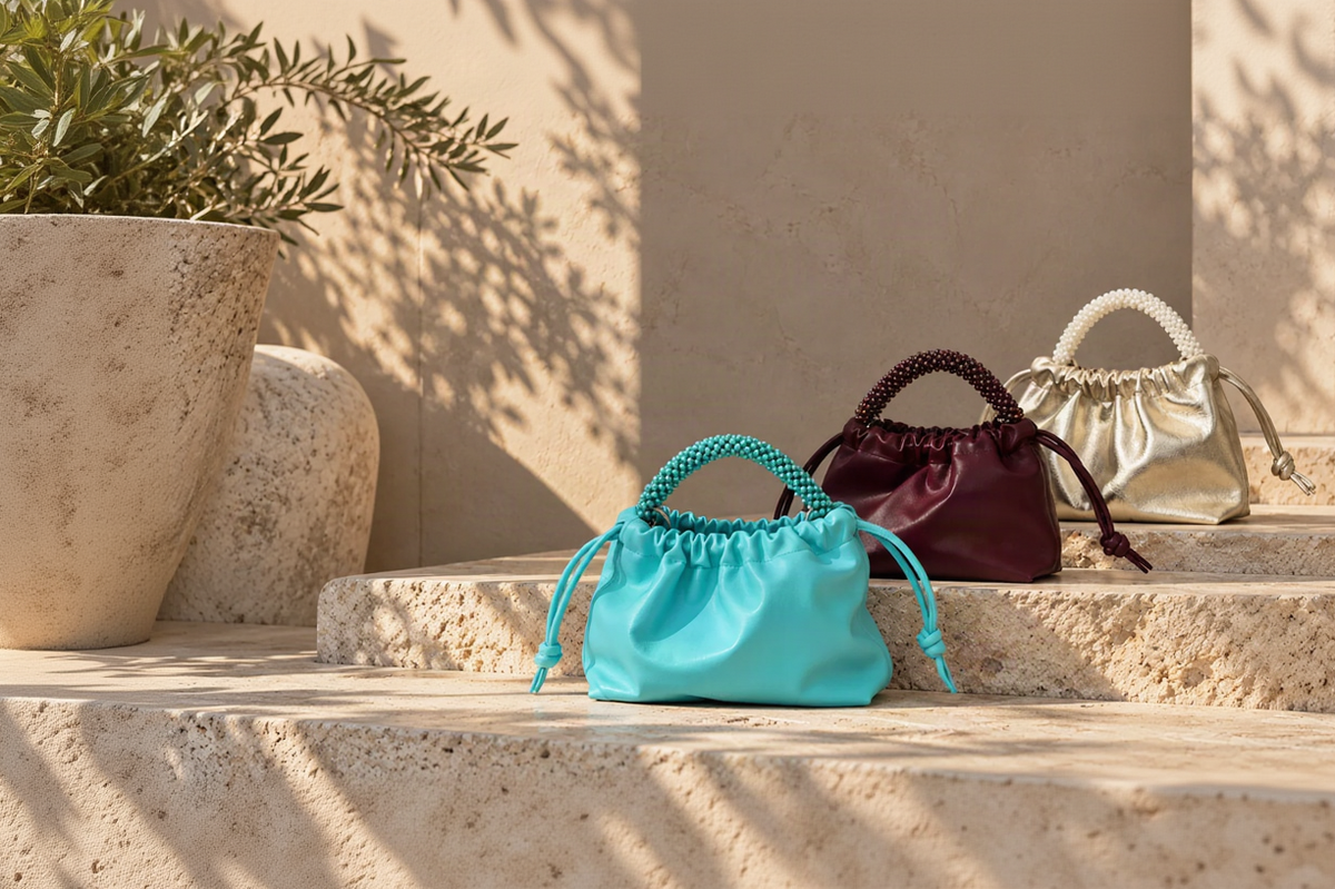 Three small drawstring pouch bags by ZOEL in turquoise, burgundy, and champagne gold and crystal beads handles.