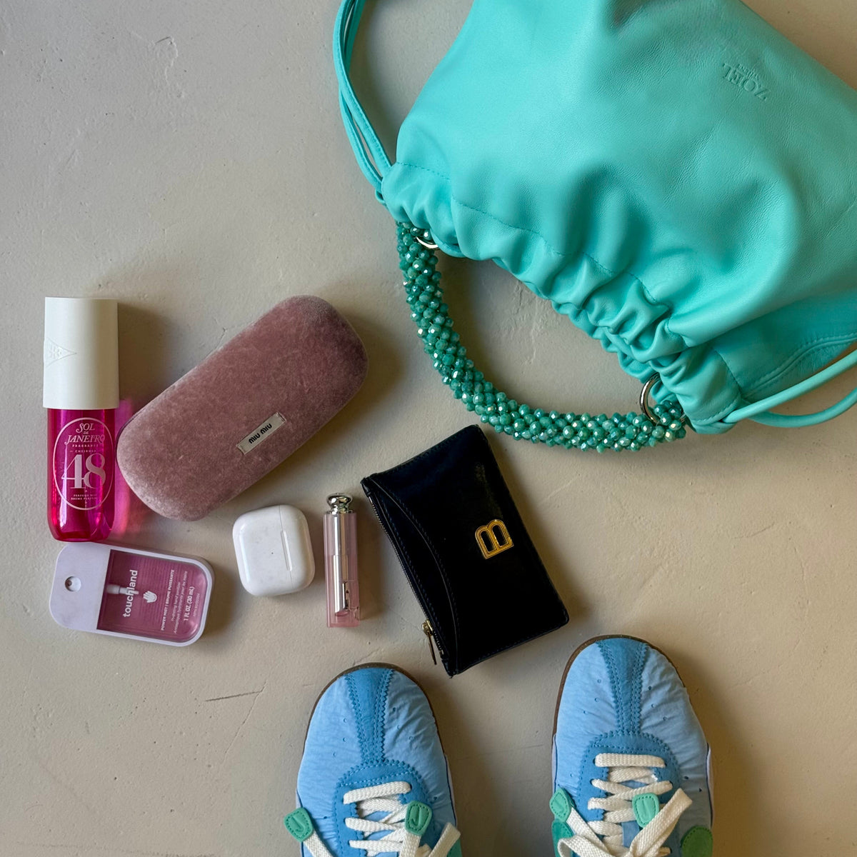 What fits in a ZOEL leather pouch bag with crystal beaded handle.